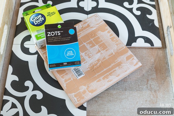 How to secure tiles to a wood tray using hot glue or Glue Dots for stability Glue Dots and Zots applied to the back of tiles for securing them in a tray