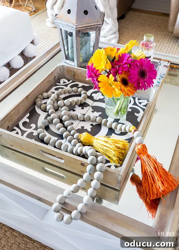 How to easily change a plain coffee table tray to a modern, hip and colorful one in an instant. Pretty black and white tile tray decorated for fall on a coffee table