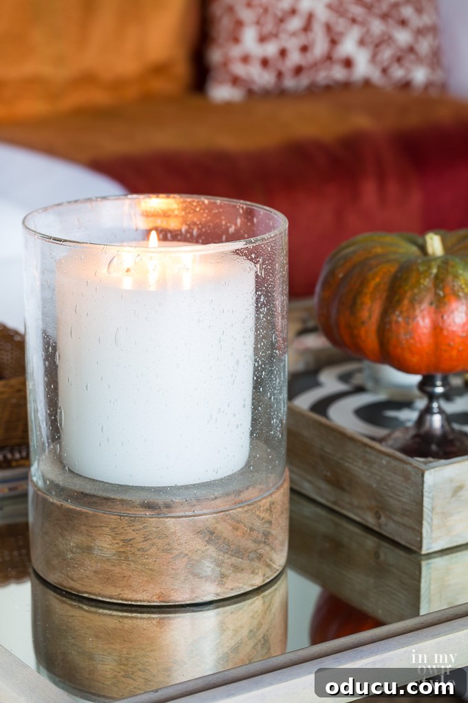 Effortless Fall Comfort: Cozy Decorating Ideas for Your Home 16 Bubble glass candle holder on table with white candle