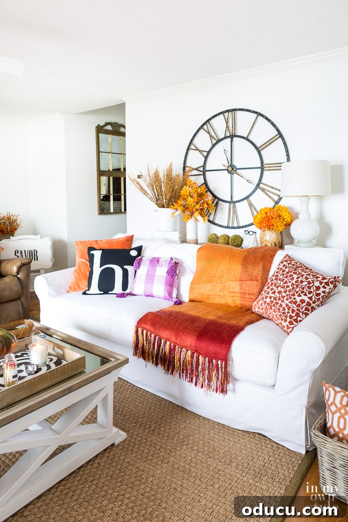Effortless Fall Comfort: Cozy Decorating Ideas for Your Home 22 Cozy living room decorated for fall with candles and throws