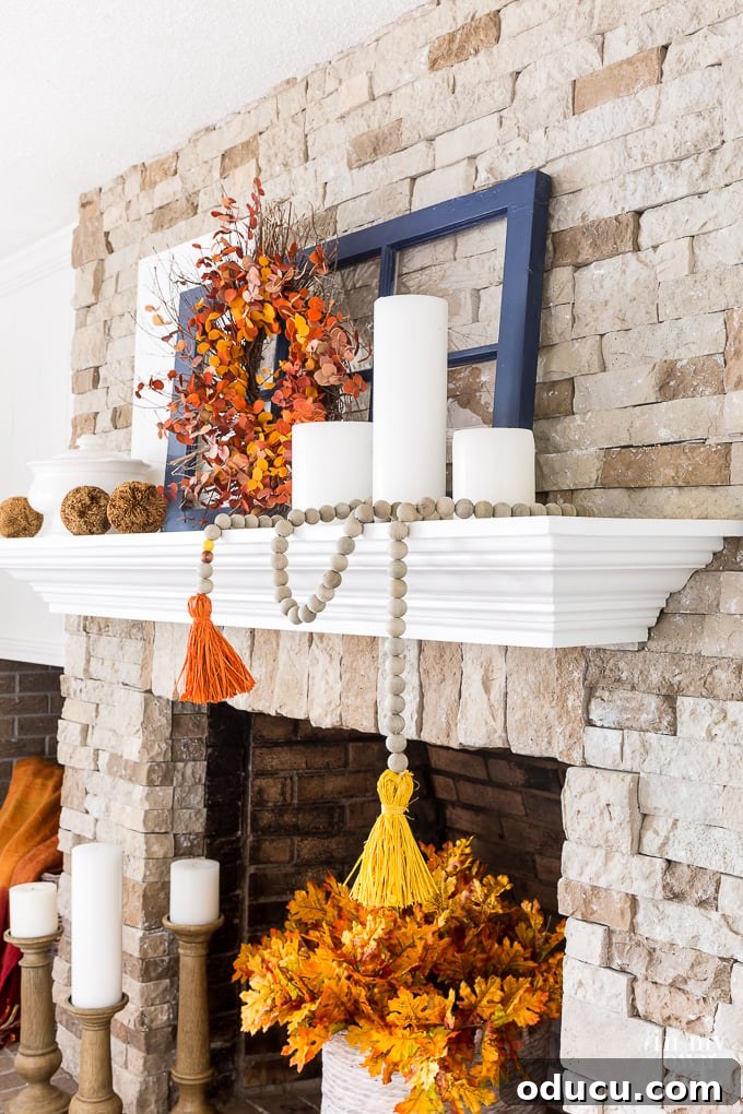 Fall mantel decorating tips that designers use to create beautiful autumn mantels and decor. #falldecorating #autumndecorating #fallmantel #falldecor #rusticfall #colorfulfalldecor #Decoratingamantel Side view of an autumn inspired decorated mantel