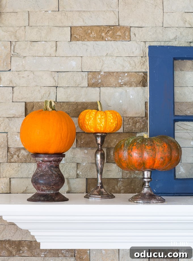 Fall decorating idea using pumpkins and candle holders Pumpkins up on pedestals for autumn decoration