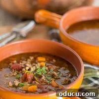 Sausage and Lentil Soup in orange bowl