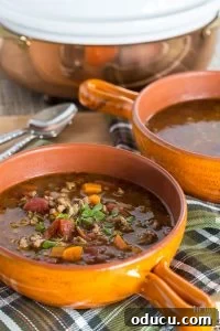 Sausage and Lentil Soup in orange bowl