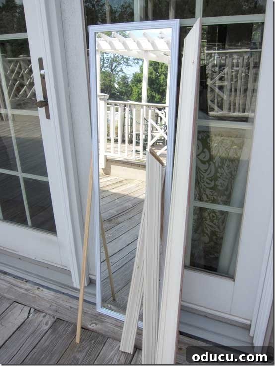 How to repurpose a mirror to make an over the door transom. Mirror and DIY supplies needed to make a fake transom