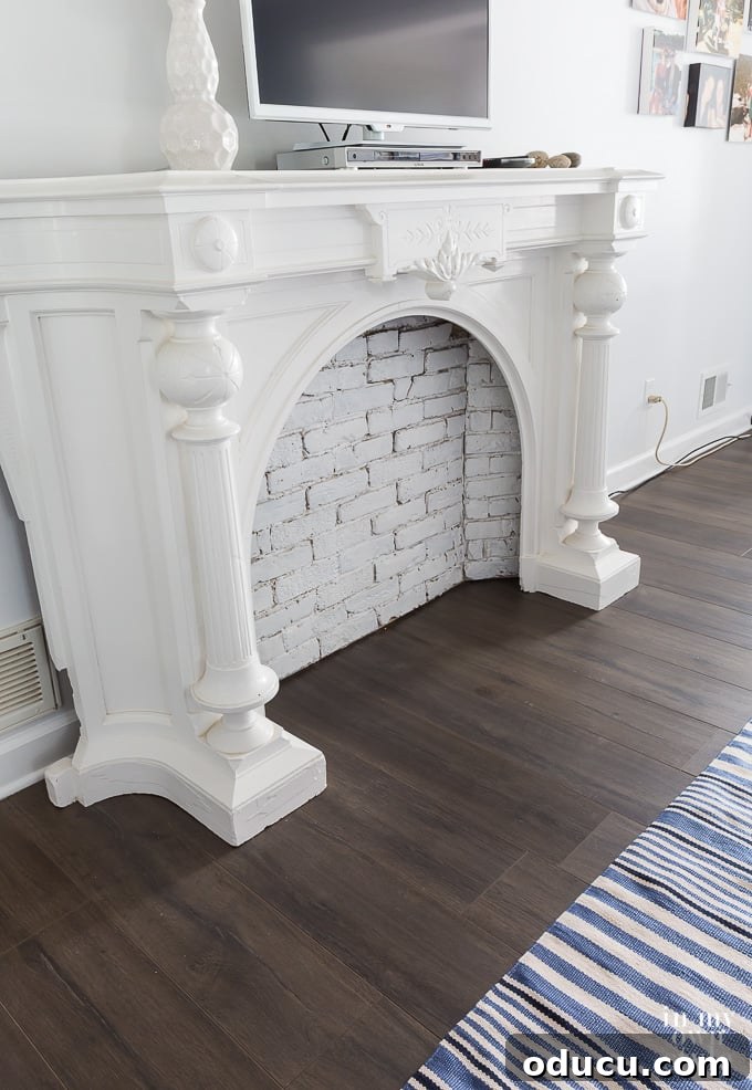 Wood laminate floor in bedroom with white mantle and light blue walls Wood laminate floor in bedroom with white mantle and light blue walls, showing the Urbanwood color.