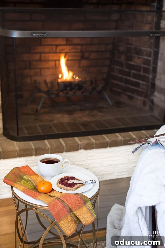 Why only make a fire in a fireplace in the evening. Breakfast set up in front of a fire with a warm cuddly throw blanket is one way to enjoy coziness in your home. Breakfast set up in front of a warm, crackling fire with a cuddly throw blanket, embodying morning coziness.