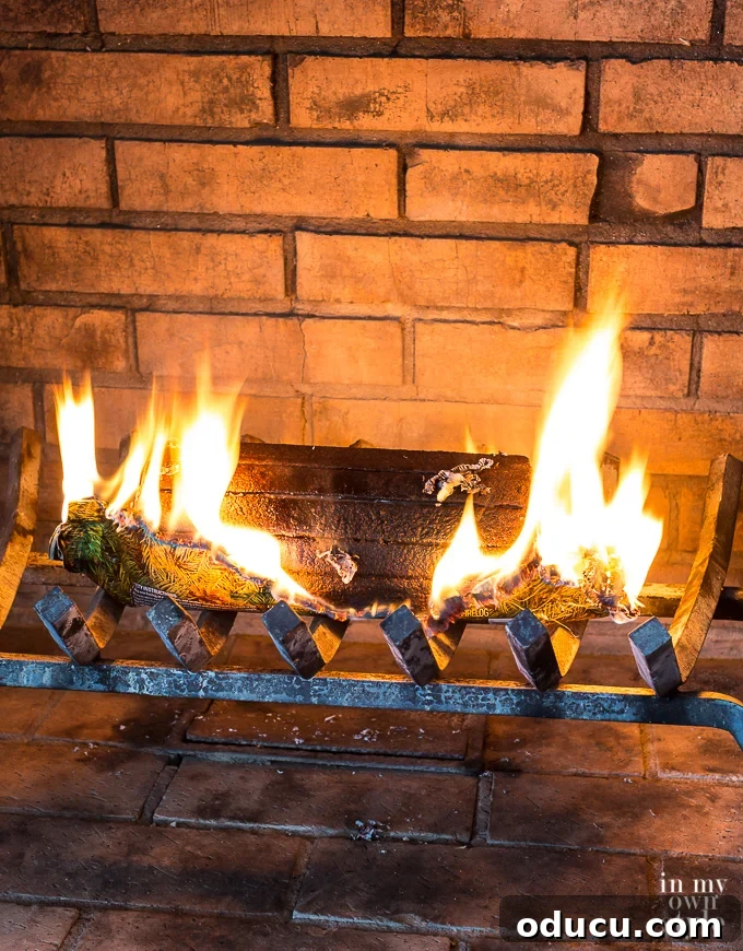 How to light a Pine Mountain firelog. A close-up of a Pine Mountain firelog burning in a fireplace, illustrating the sustained flame and warmth.