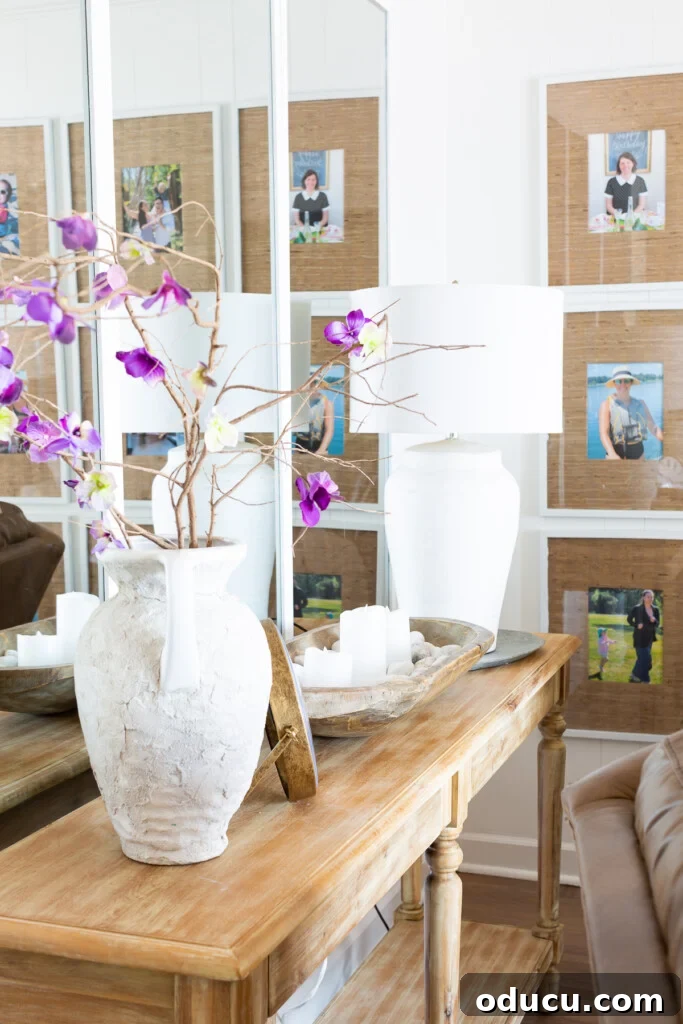 Illuminate Your Space: Easy Hacks for a Brighter Room 5 A living room decorated for summer, featuring three large framed mirrors hung side-by-side across from a sliding glass door, reflecting abundant light.