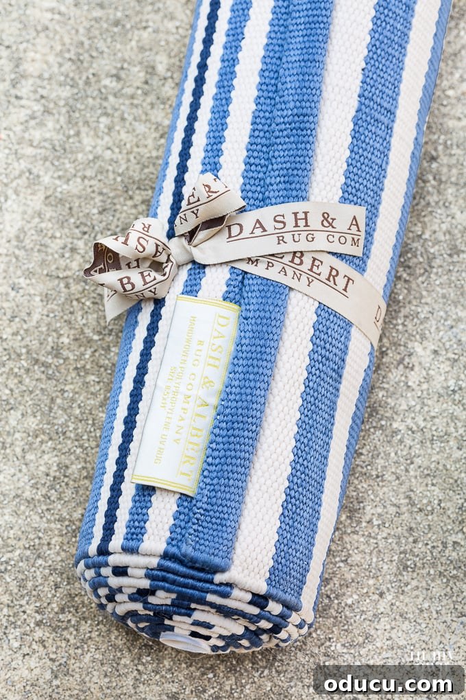 The Perfect Rug Size for Your Bed 2 Dash and Albert Rugby Stripe area rug rolled up