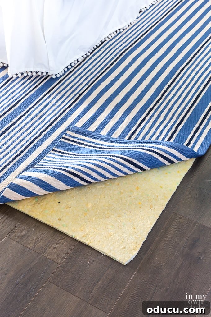 Why you need a rug pad under an area rug. 1/4" foam padding under area rug in bedroom