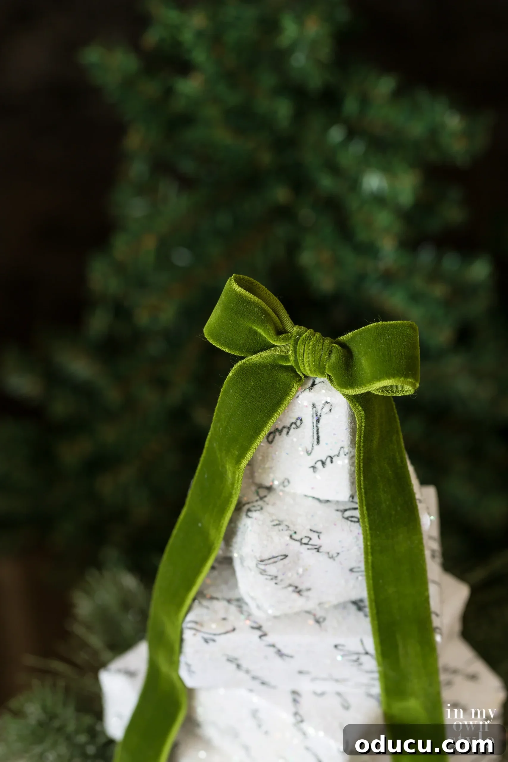 Two variations of a DIY stacked box Christmas tree, one freestanding and one on a dowel.