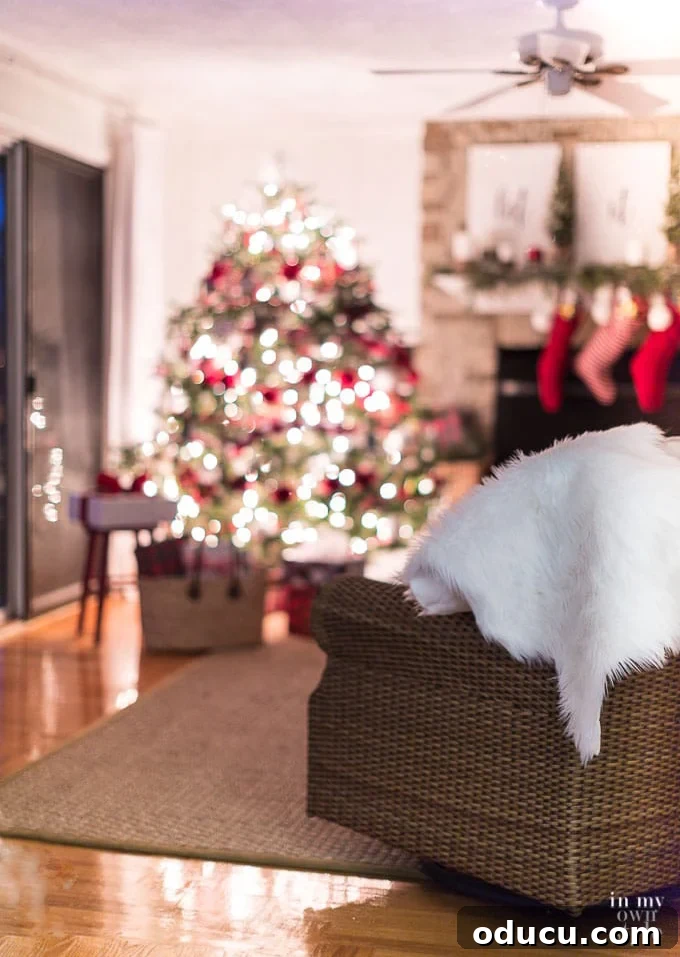 What are the best lights to use on a Christmas tree? A warmly lit Christmas tree stands in a cozy living room at night, adorned with white twinkle lights that cast a magical glow.