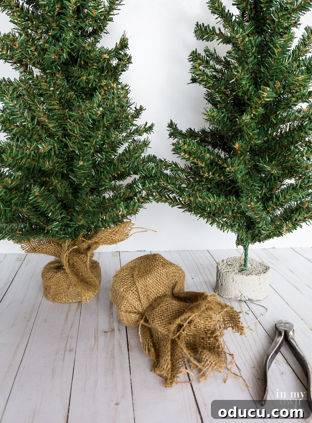 Tiny Tree, Big Style: Base Decor Hacks 2 Small Christmas tree with burlap base restyled with a sleek metal base. An easy and budget-friendly DIY project for unique holiday decor.