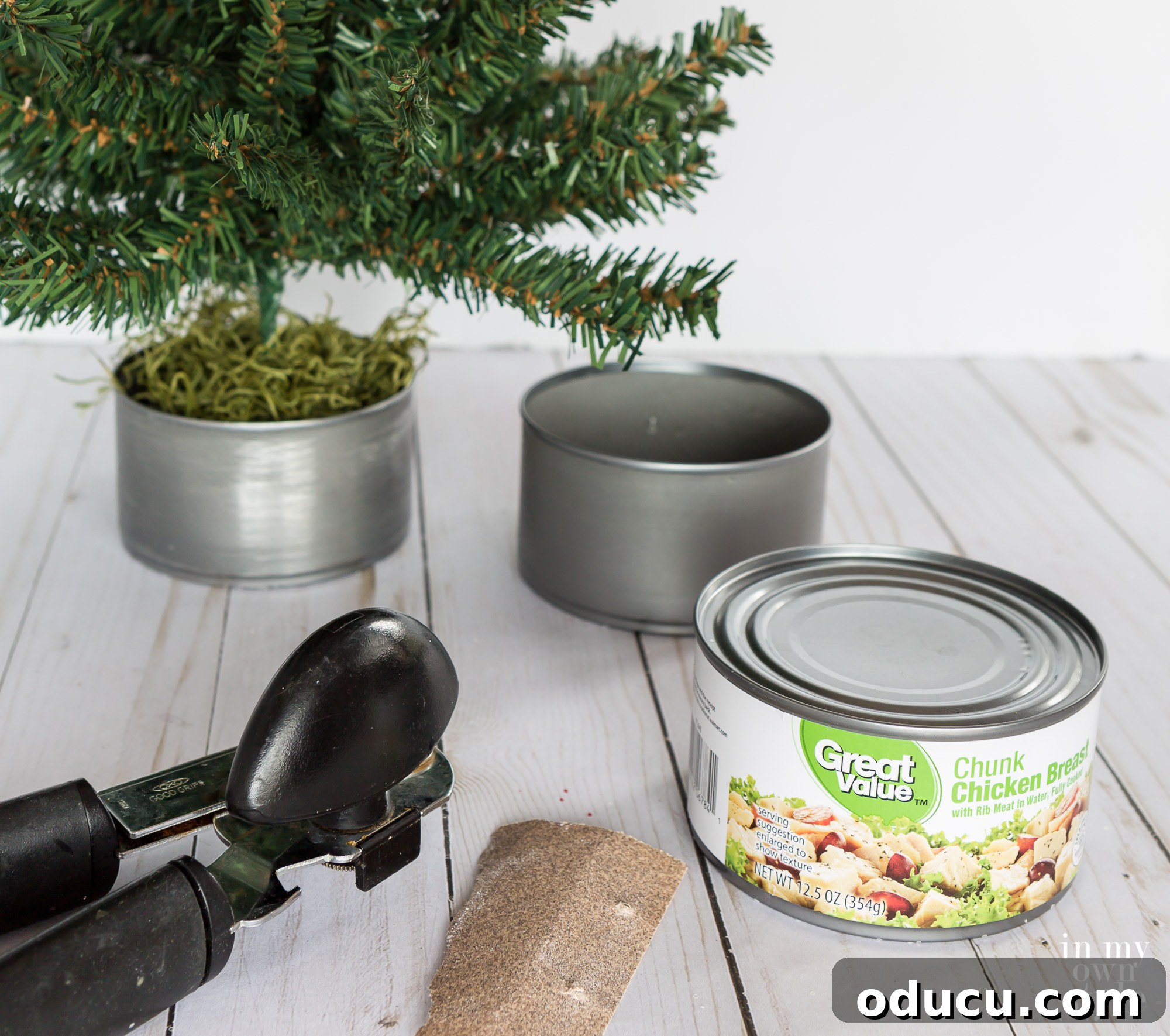 Tiny Tree, Big Style: Base Decor Hacks 3 Metal tuna and chicken cans are excellent, versatile options for creating stylish and stable mini Christmas tree bases.