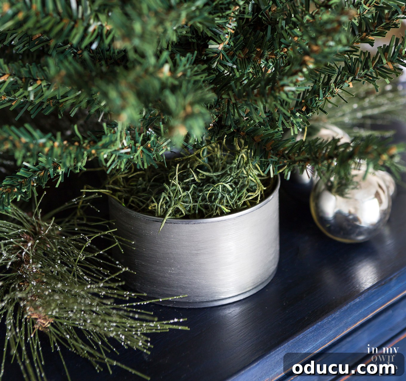 Tiny Tree, Big Style: Base Decor Hacks 5 Achieve a Fixer Upper-style mini Christmas tree base effortlessly using common pantry items. A creative, budget-friendly holiday decorating idea.