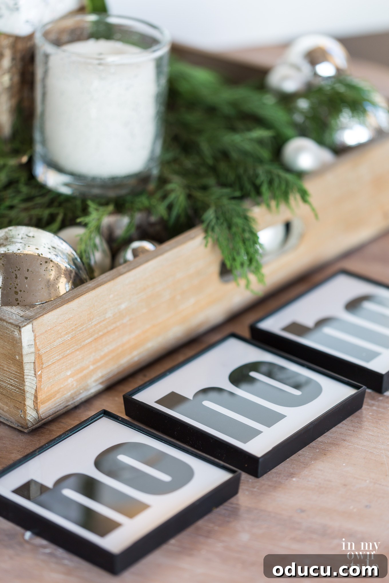 Instant Holiday Cheer: Free Printable Drink Coaster Designs 5 Ho ho ho Holiday drink coasters on a table decorated for Christmas.