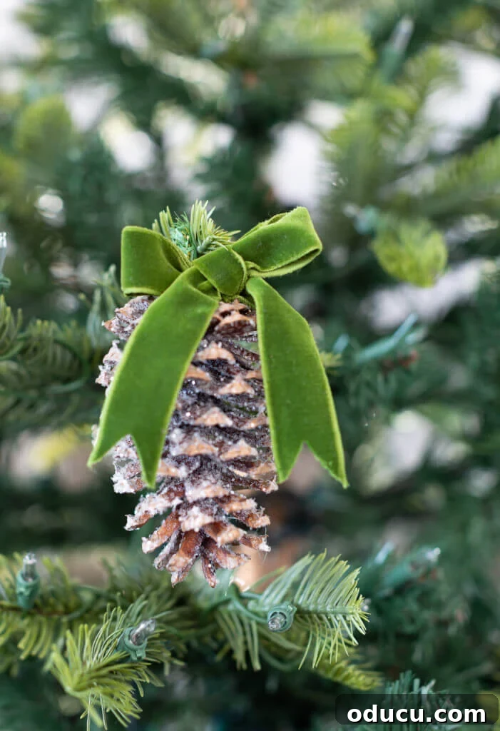 Beyond Baubles: Creative Tree Styling 11 Close up of a pinecone made into a Christmas tree ornament with glitter.