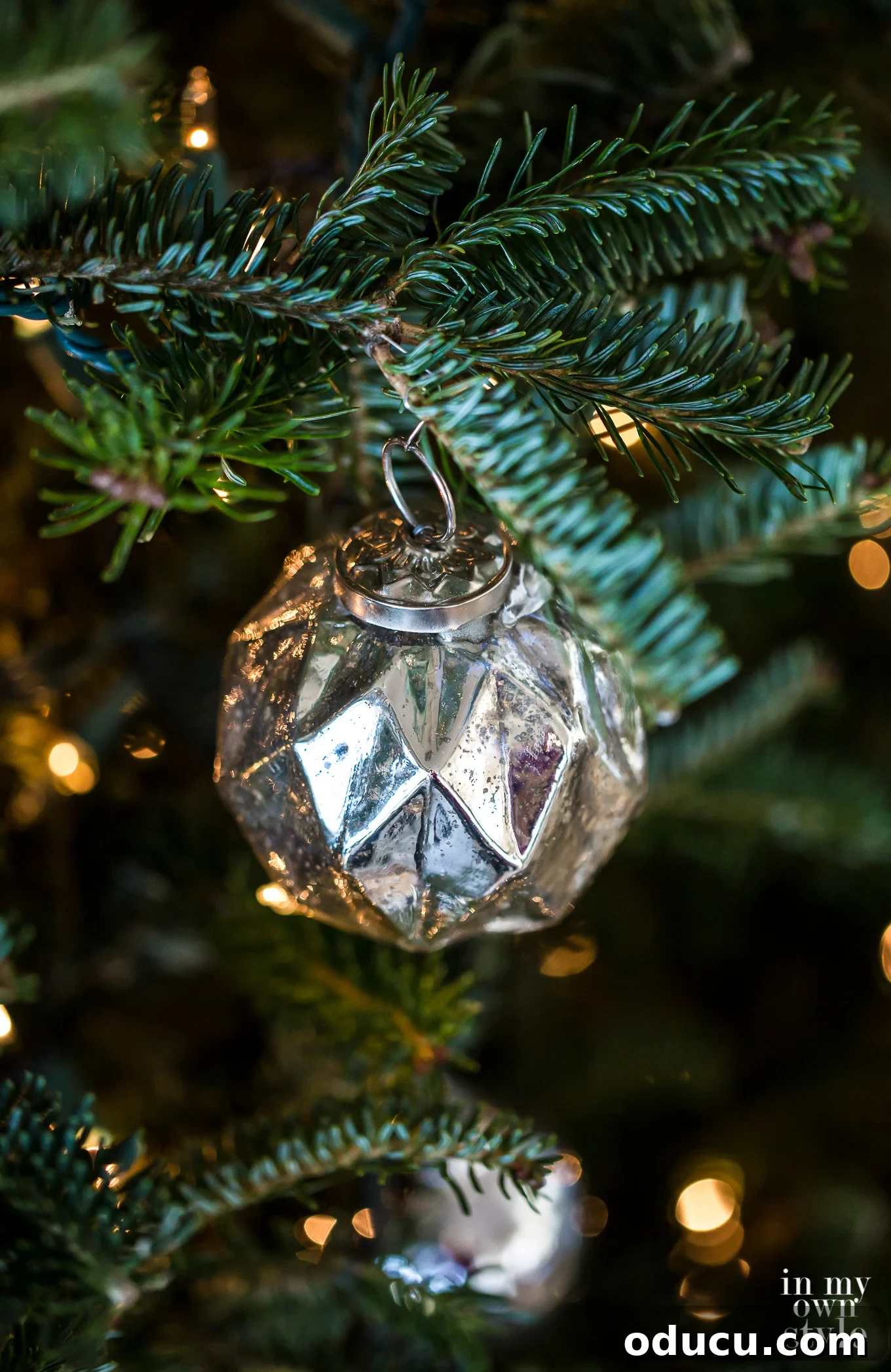 Beyond Baubles: Creative Tree Styling 14 Close up of another vintage silver Christmas tree ornament reflecting lights