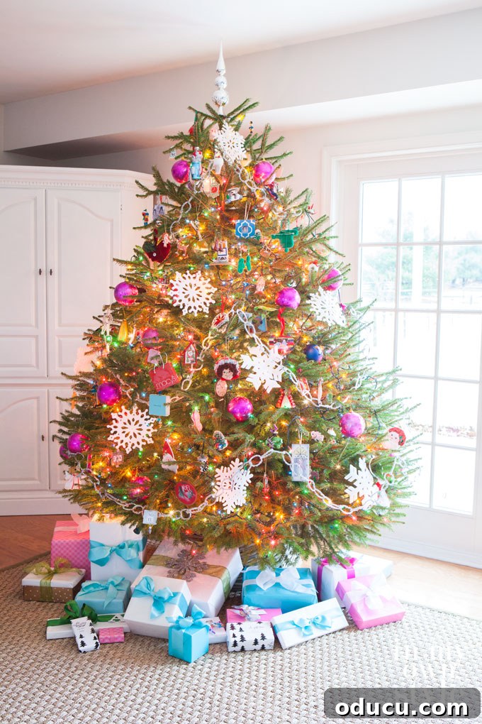 Beyond Baubles: Creative Tree Styling 5 Decorating a Christmas Tree with pink balls and snowflakes