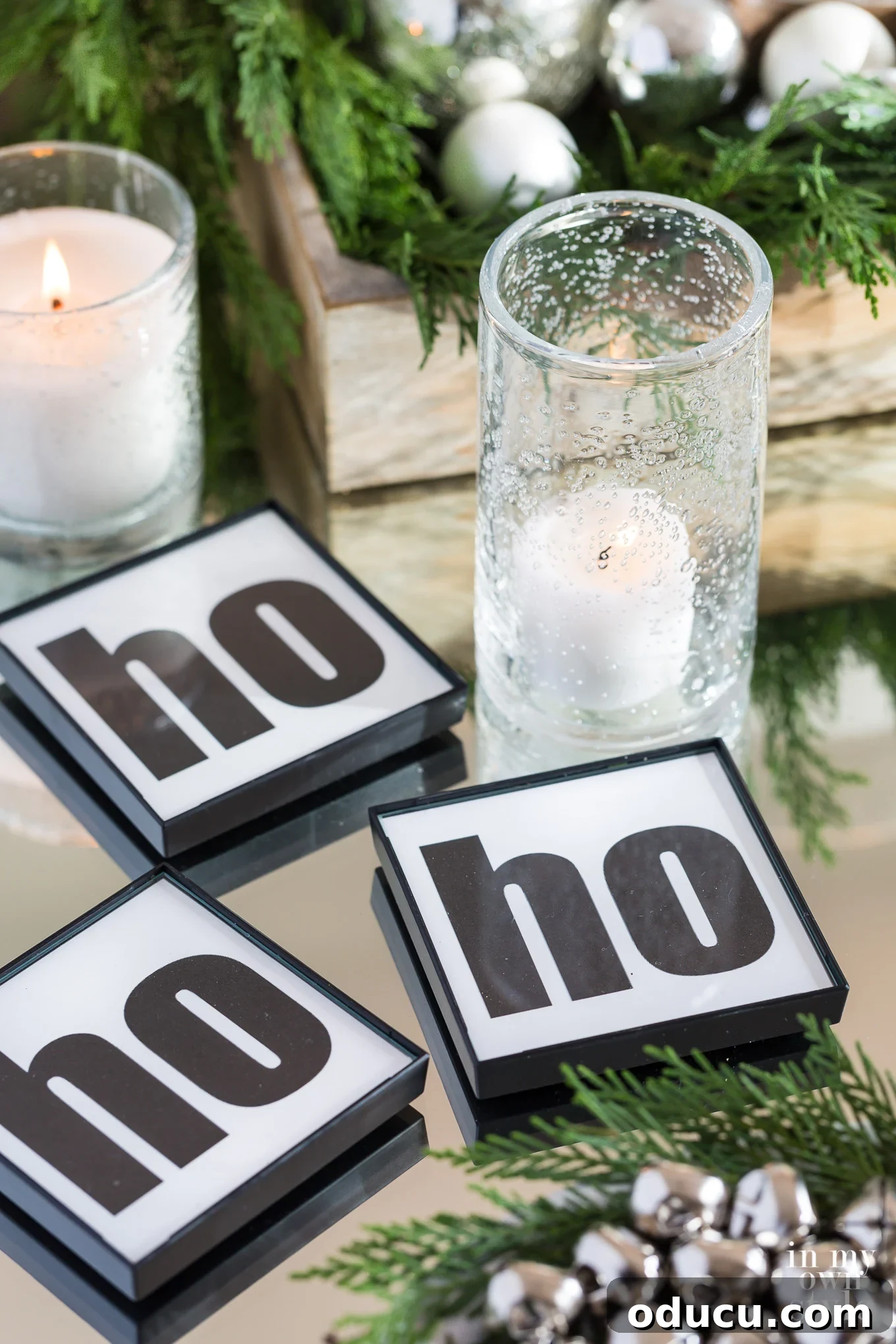 DIY black and white HO HO HO coasters on table DIY black and white HO HO HO coasters on table, a fun personalized detail
