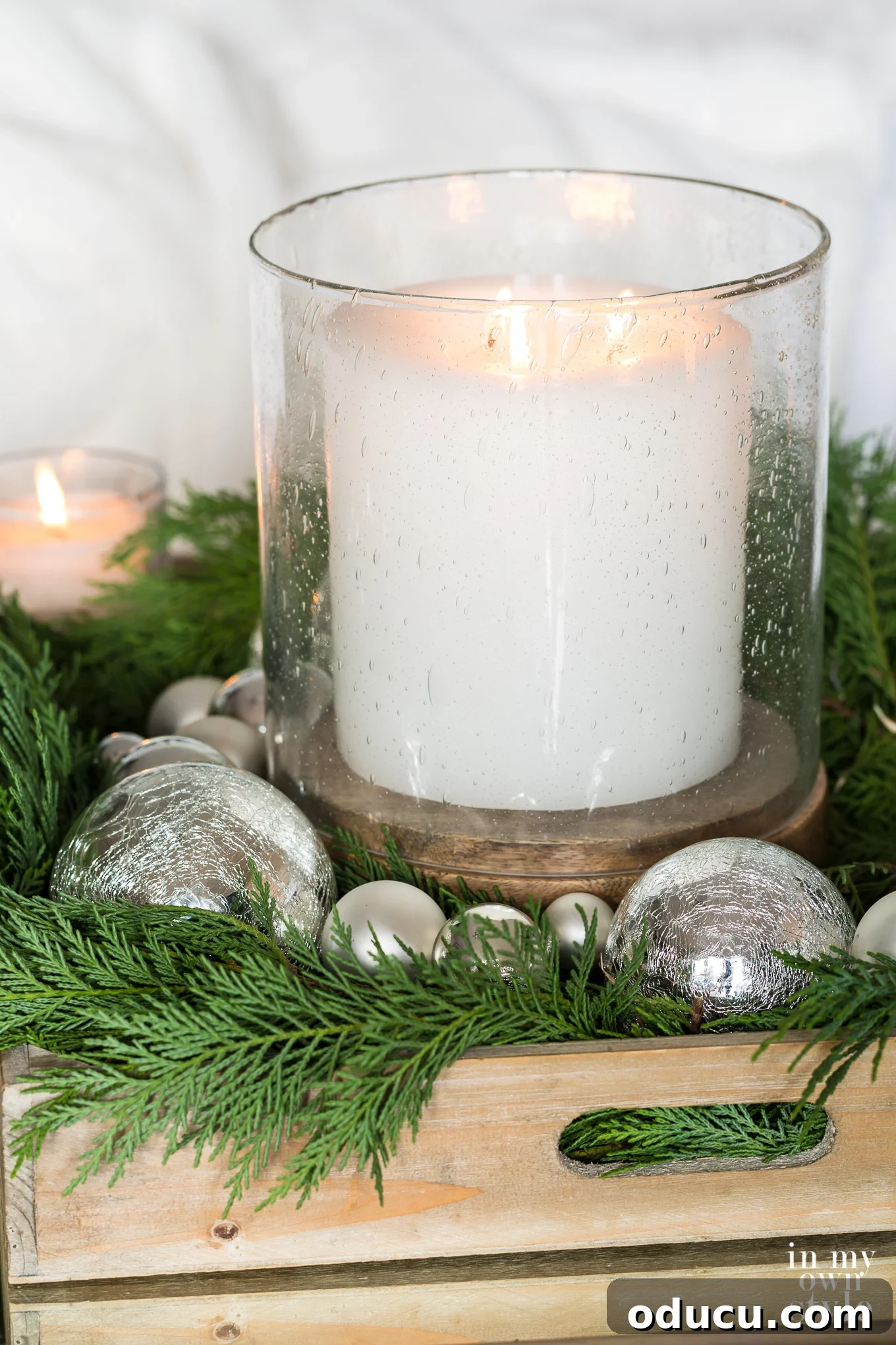 Decorating with candles for the holidays. #Easy #Christmas #decorate #candledecorations Bubble glass hurricane with large white candle inside, casting a soft, inviting glow