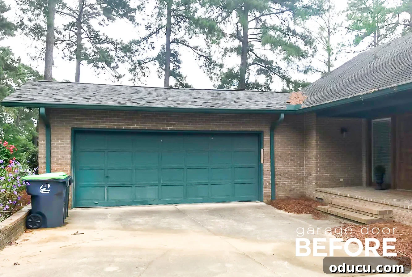 Paint Your Garage Door to Mimic Stained Wood: A DIY Transformation 2 Faded and peeling green garage door before painting to look like wood