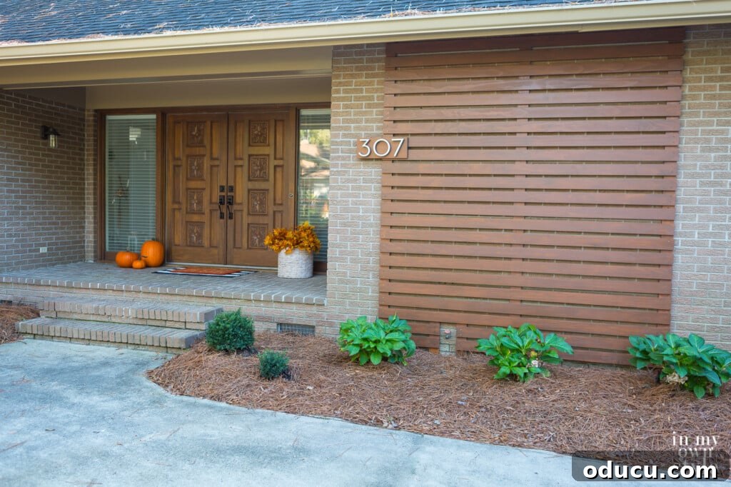 Paint Your Garage Door to Mimic Stained Wood: A DIY Transformation 15 Slat wall on exterior of house after facade makeover, complementing the painted garage door