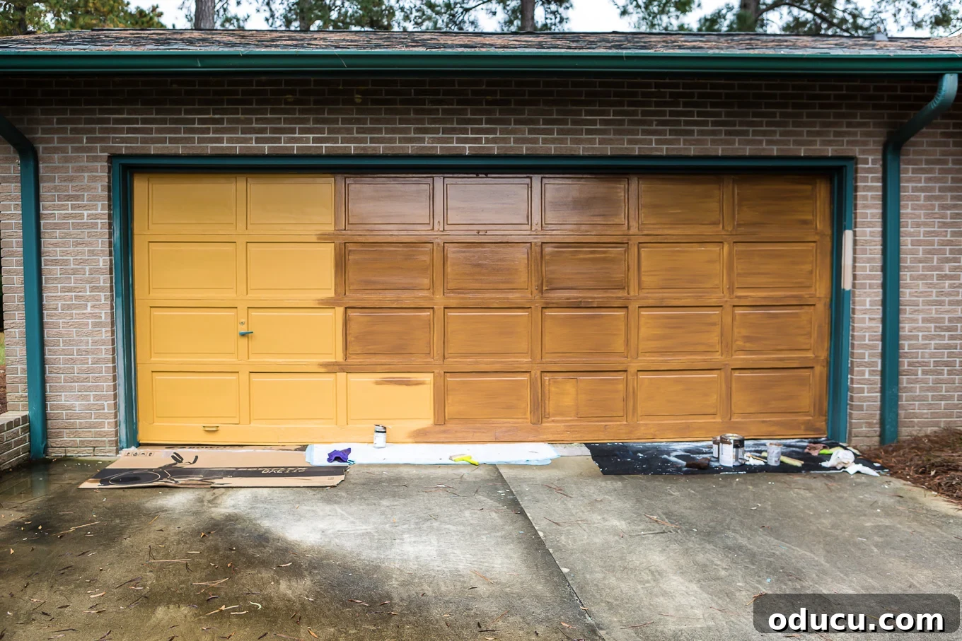 Paint Your Garage Door to Mimic Stained Wood: A DIY Transformation 8 Applying the brown paint and glaze mixture to a garage door for a faux woodgrain look
