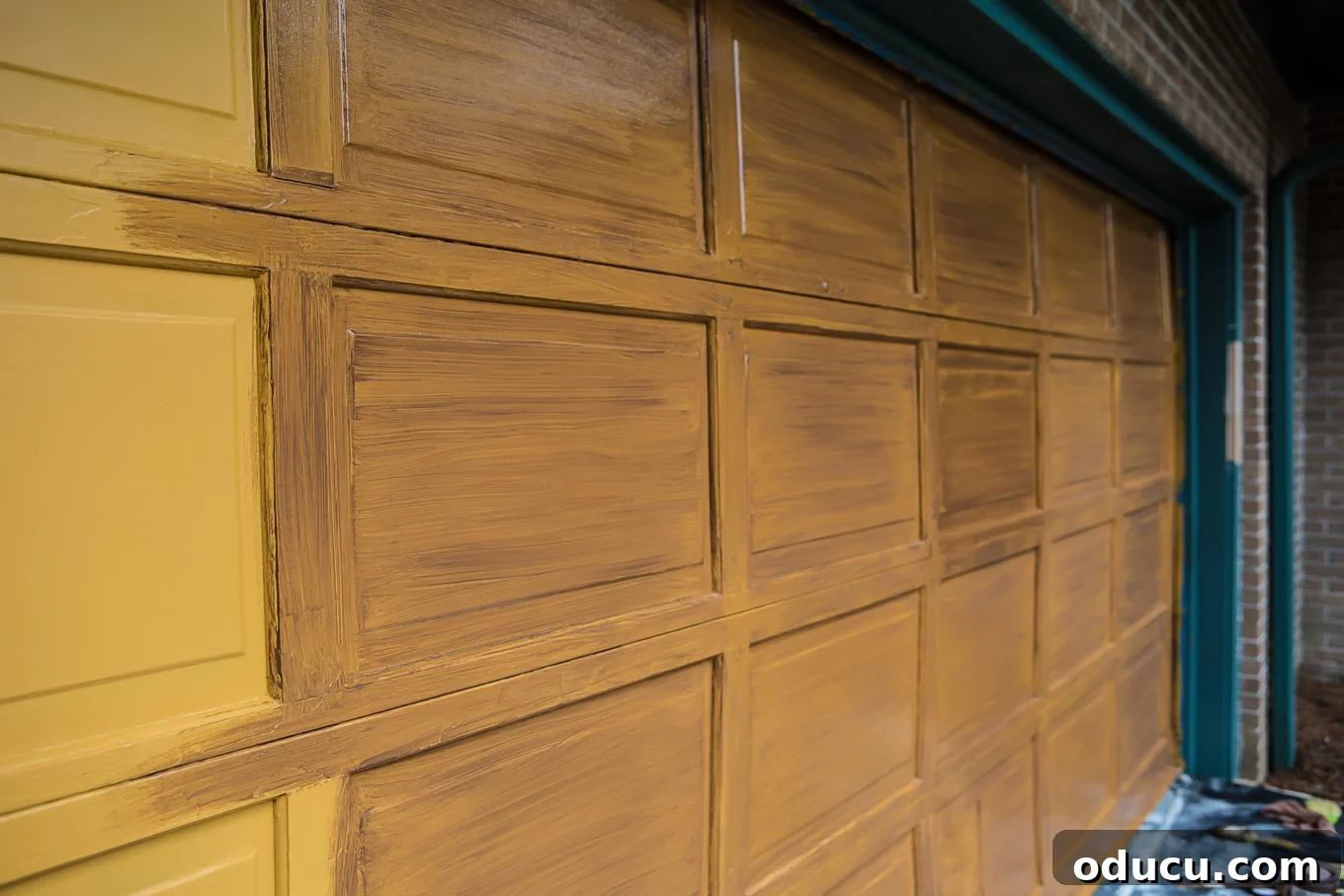 Paint Your Garage Door to Mimic Stained Wood: A DIY Transformation 9 Using a whisk broom to create faux woodgrain texture on a wet glaze coat