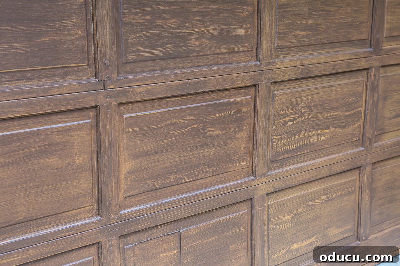 Paint Your Garage Door to Mimic Stained Wood: A DIY Transformation 10 Finished section of a garage door with faux woodgrain, showing the stained wood effect