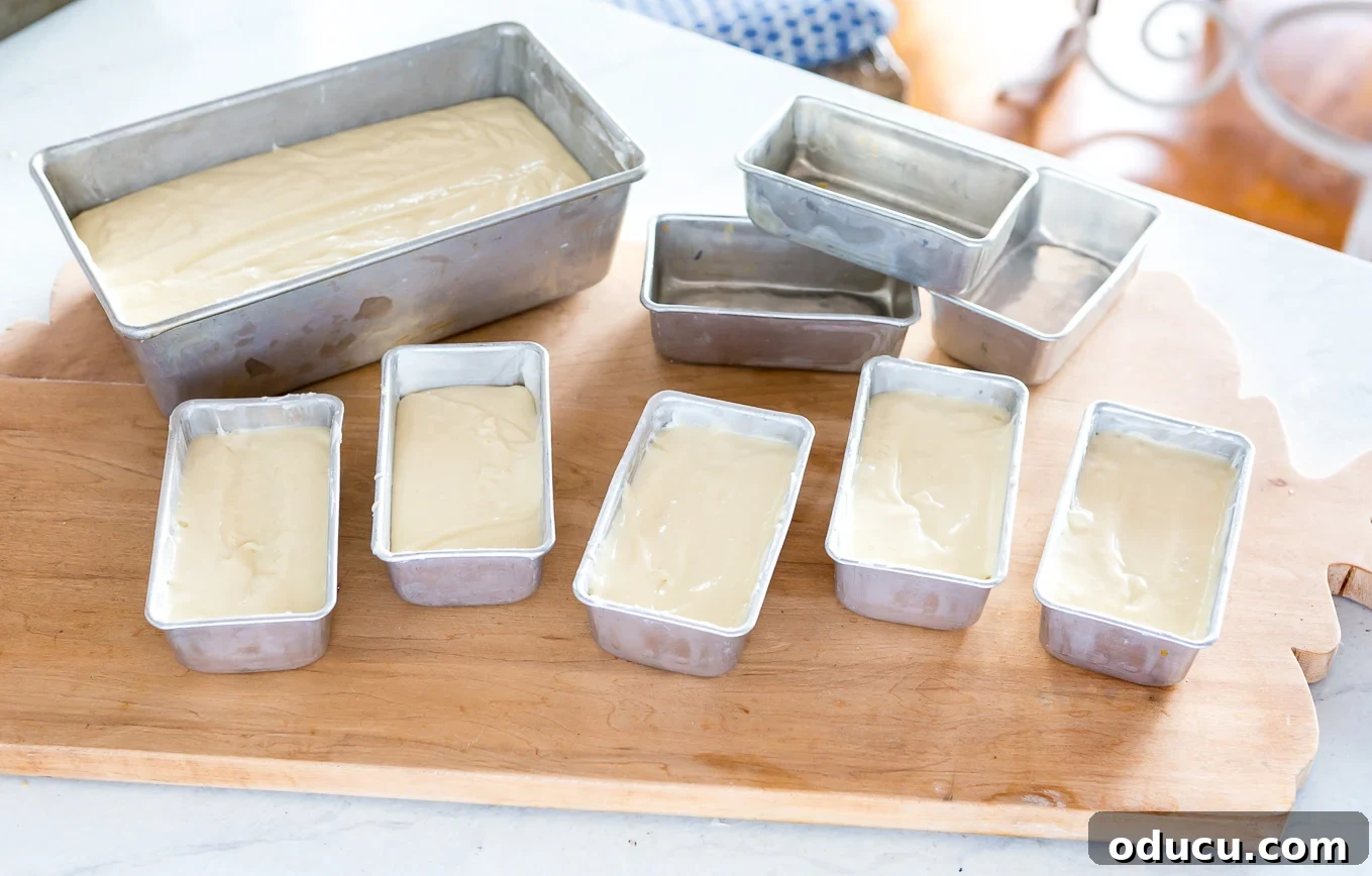 Elevate Your Loaf Cake Gifts with Festive Wrapping 8 Mini loaf pans filled with Old Fashioned Lemon Pound Cake batter, ready for baking.