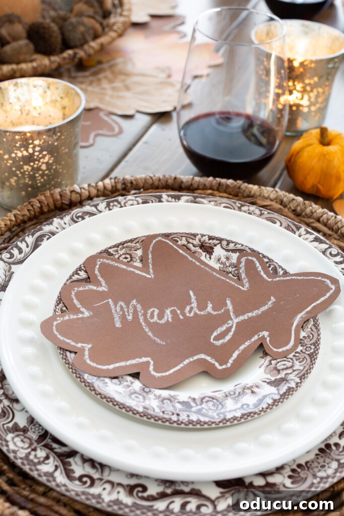 brown paper oak leaf place card on top of a dinner plate on a table