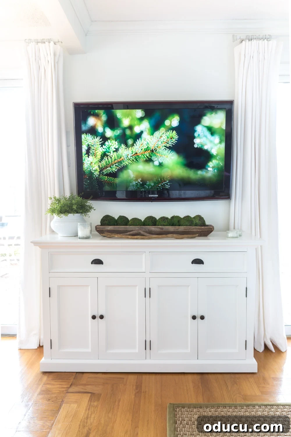 White furniture under wall mounted TV