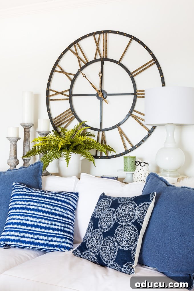 How to arrange long stem fake flowers in a glass vase in living room decor