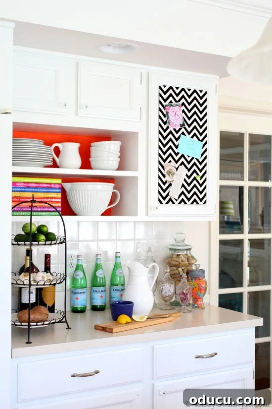 Kitchen with Cardboard from large boxes were used to make the decorative backdrops for the shelves and the memo board. Kitchen-Decorating-Ideas-on-a-Budget-using-colorful fabric ad giftwrap