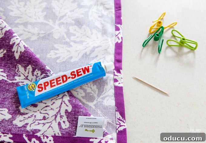 How to no sew decorating techniques and tips for decorating on a really small budget purple leaf fabric getting made into a pillow using a no sew fabric glue.