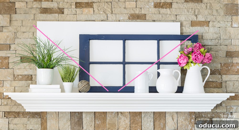 Decorate a Mantel Like a Designer using the elements and principles of design. A striking mantel decor arrangement where items are placed to form an inverted pyramid, demonstrating a clever application of design principles for a unique visual impact.