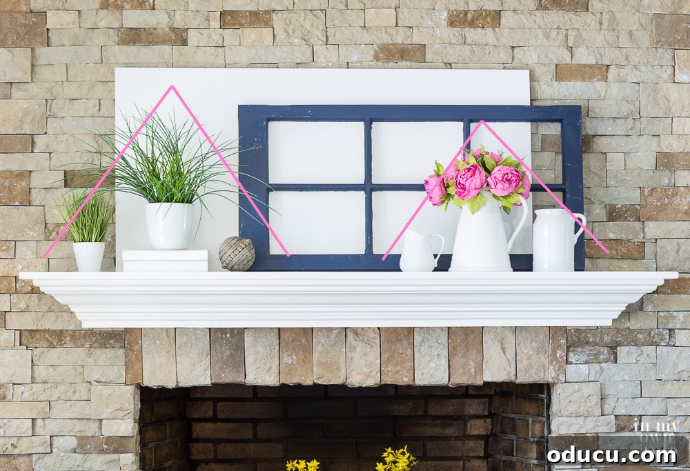 One of many ways to decorate a mantel for any season. A versatile mantel design featuring two distinct pyramid arrangements, demonstrating effective use of symmetry and visual weight for any season.