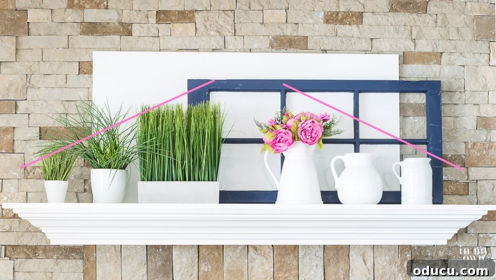 Using a collection of white pitchers to decorate a mantel. A mantel styled with a collection of white pitchers, demonstrating varying heights and strategic placement to achieve visual balance and interest.