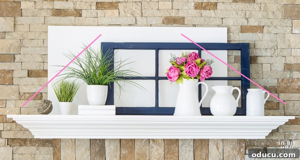 Decorating-tips-for-fireplace-mantels A fireplace mantel display showcasing items arranged from smallest to largest on each side, forming a pyramid shape for balanced aesthetics.