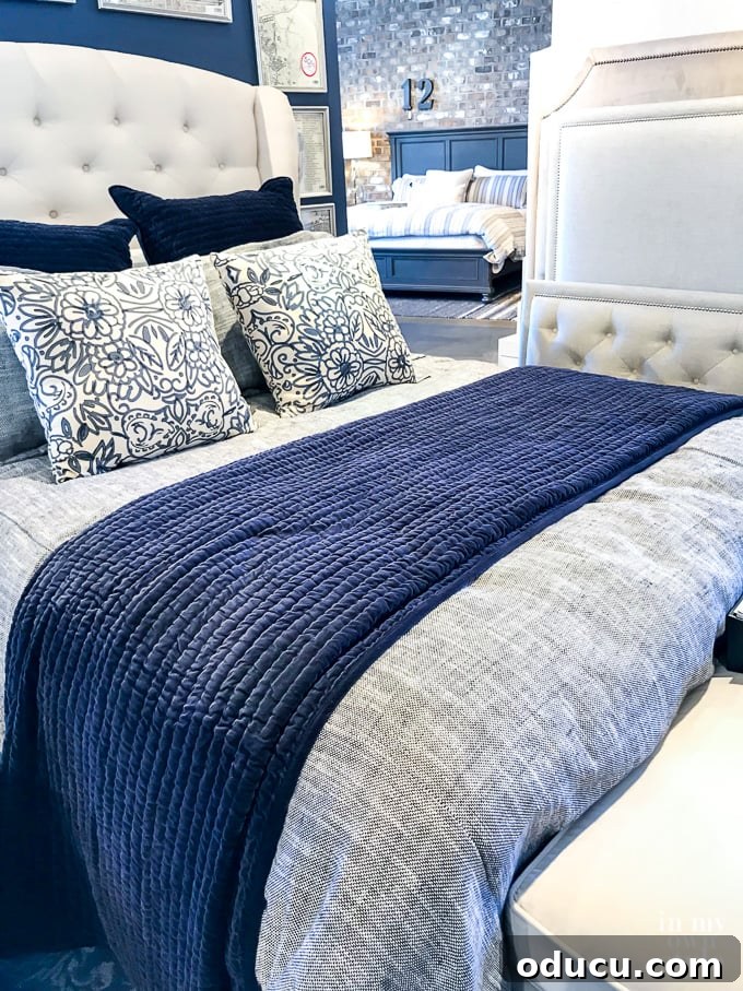 Embracing the SLOW Method for Mindful Decorating 2 Stunning navy and white bedding display in a furniture store, inspiring a budget-friendly bedroom makeover