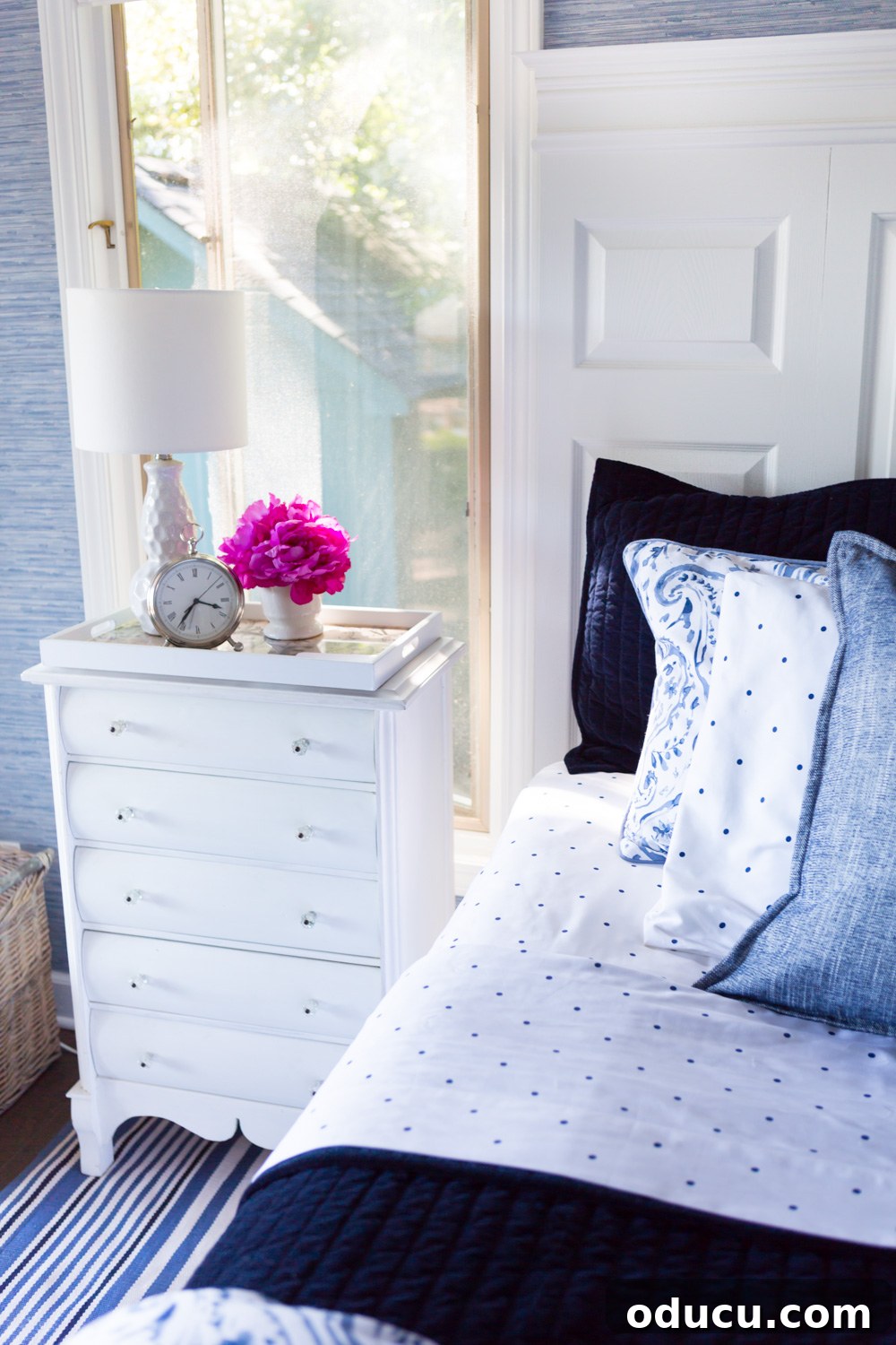 Embracing the SLOW Method for Mindful Decorating 7 Bedroom interior showcasing white painted furniture against a stylish blue and white decorated bed
