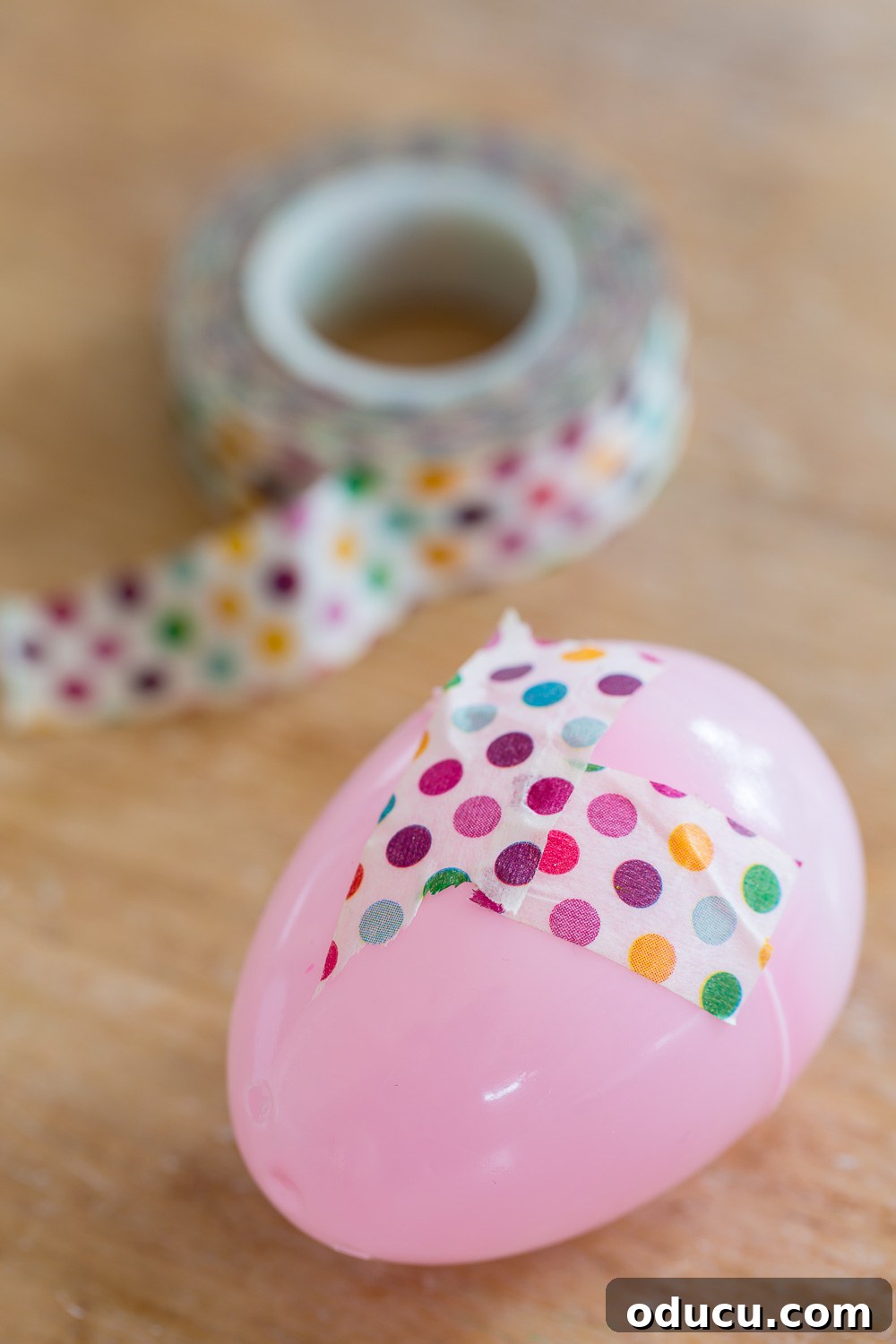Step-by-step guide: How to add Washi tape to decorate a plastic Easter egg easily.