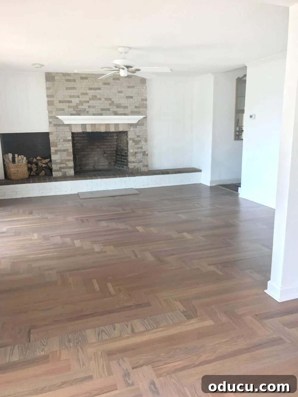 Living room with newly refinished hardwood floor in Bona DriFast Grey stain with matte sealer