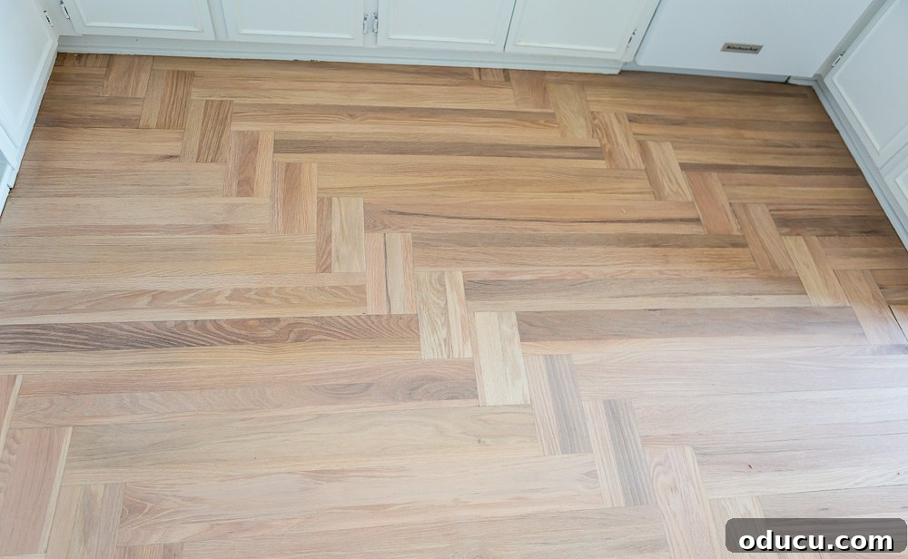 Hardwood floor in kitchen after amber orange stain has been sanded off