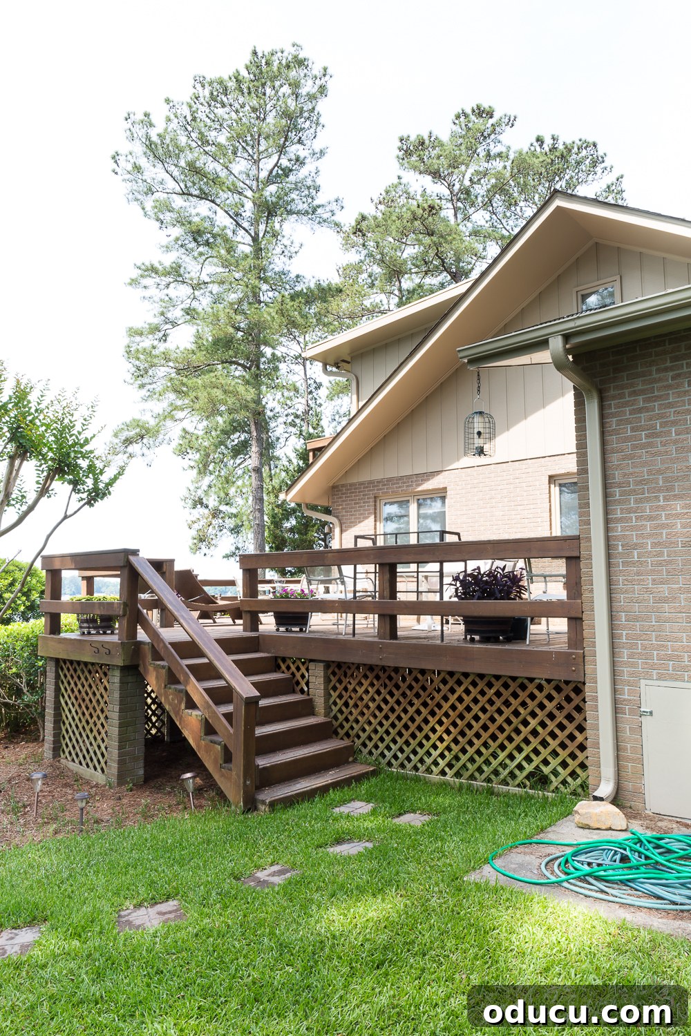 From Faded to Flawless: Exterior Home Painting 16 Side of house that shows the transition from Ranch style front facade to two story lake side