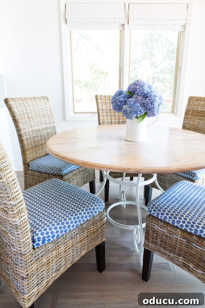 Hardwood Floor Revival: A New Beginning 11 Round wood kitchen table and driftwood colored woven chairs in kitchen.