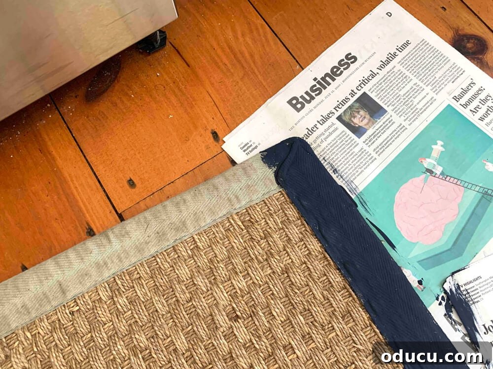 Customizing Your Seagrass Rug with Paint 14 Blog reader sent photo showing how she was inspired by my rug border painting post and started it on her rug using navy paint.