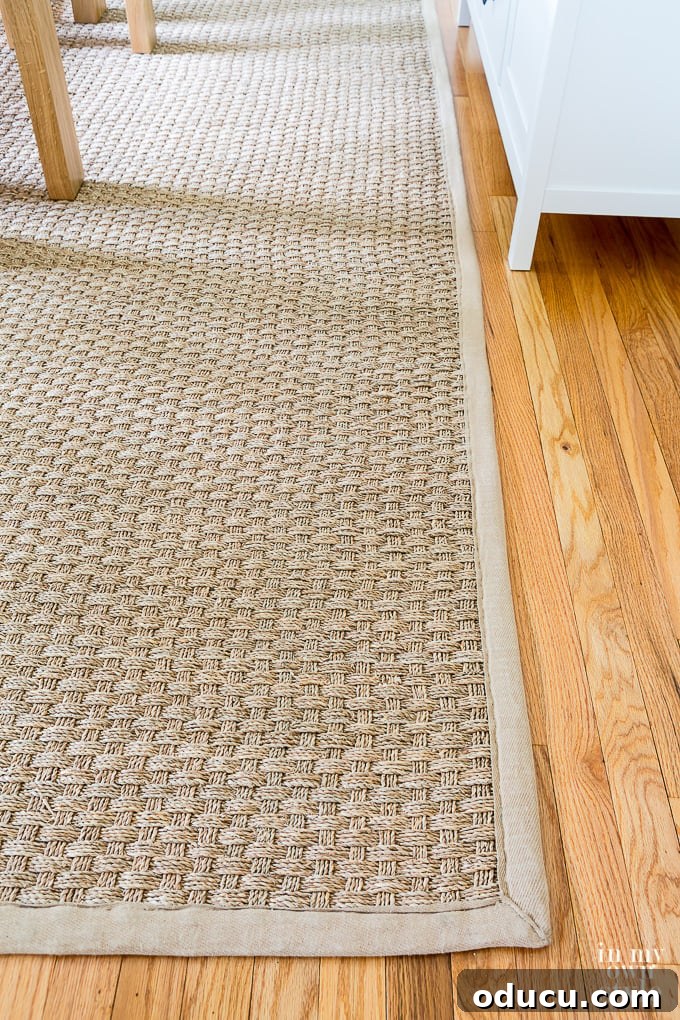 Customizing Your Seagrass Rug with Paint 6 Seagrass rug with neutral beige trim in dining room.